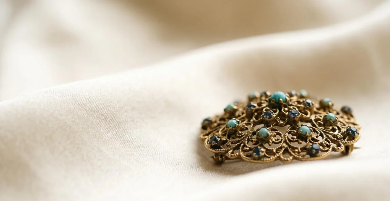 Broche ornementale délicate reposant sur tissu de soie luxueux avec surface lisse intacte